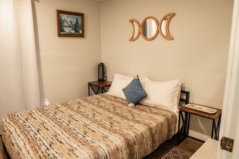 Bedroom 1 with queen bed and moon decor
