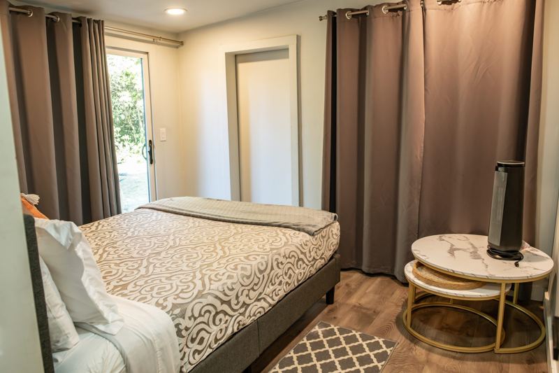 Bedroom 2 with a glass door to the woods